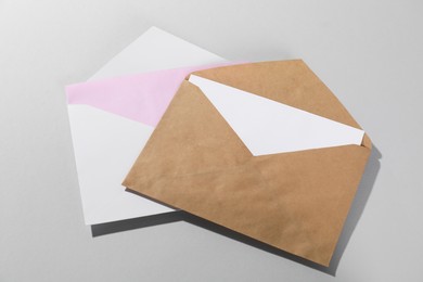 Paper envelopes with letters on grey background, above view. Mockup for design