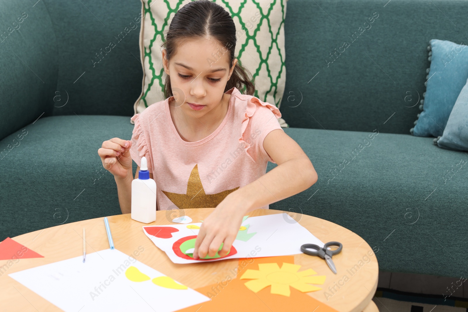 Photo of Girl making art project at table indoors