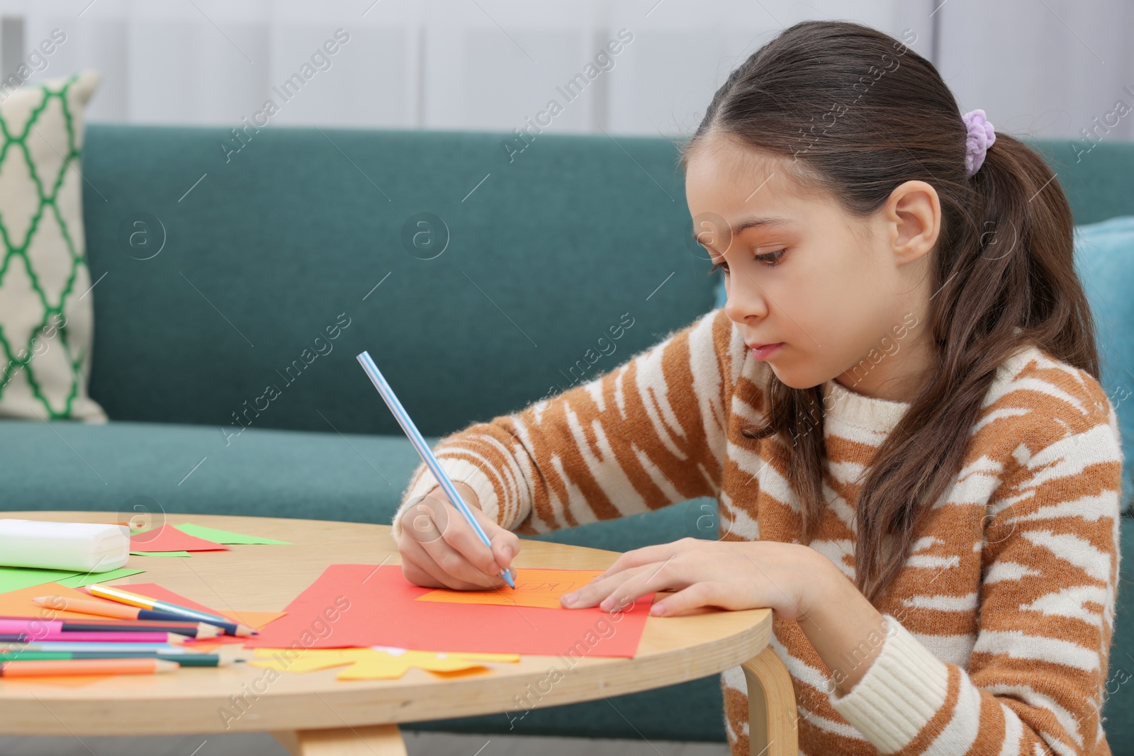 Photo of Girl drawing card at table indoors. Art and craft