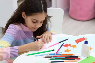 Photo of Girl drawing card at table indoors. Art and craft