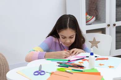 Photo of Girl drawing card at table indoors. Art and craft