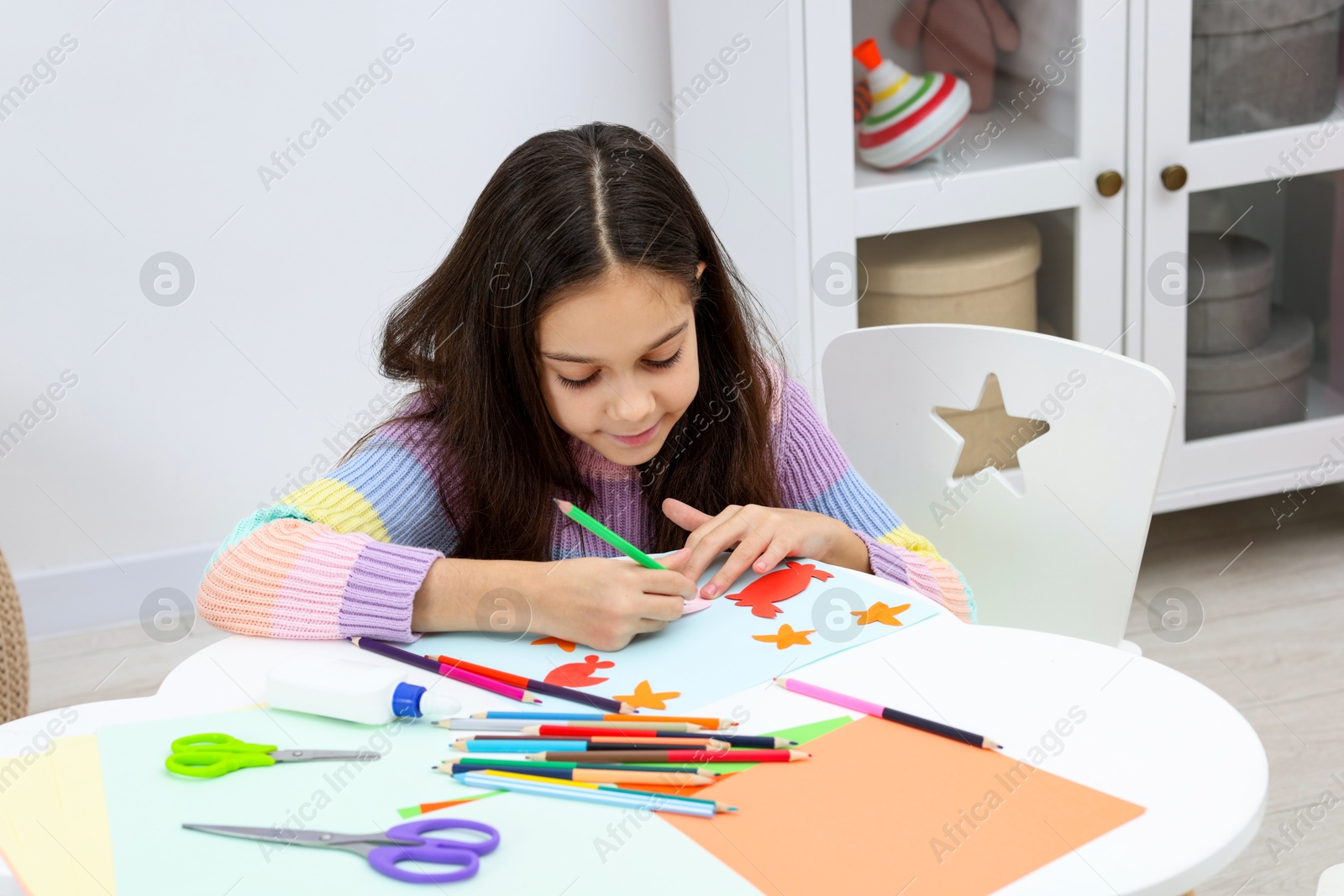 Photo of Girl drawing card at table indoors. Art and craft