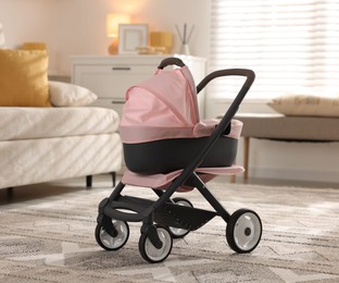 Photo of Doll stroller in living room. Kid's toy