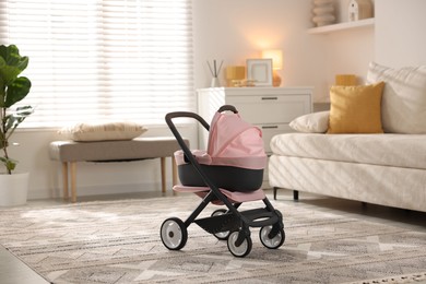 Photo of Doll stroller in living room. Kid's toy