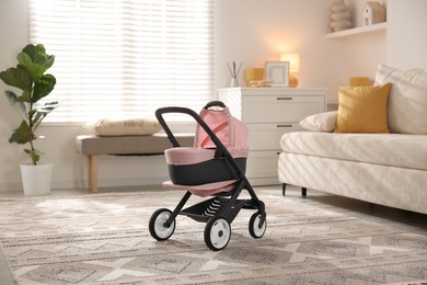 Photo of Doll stroller in living room. Kid's toy