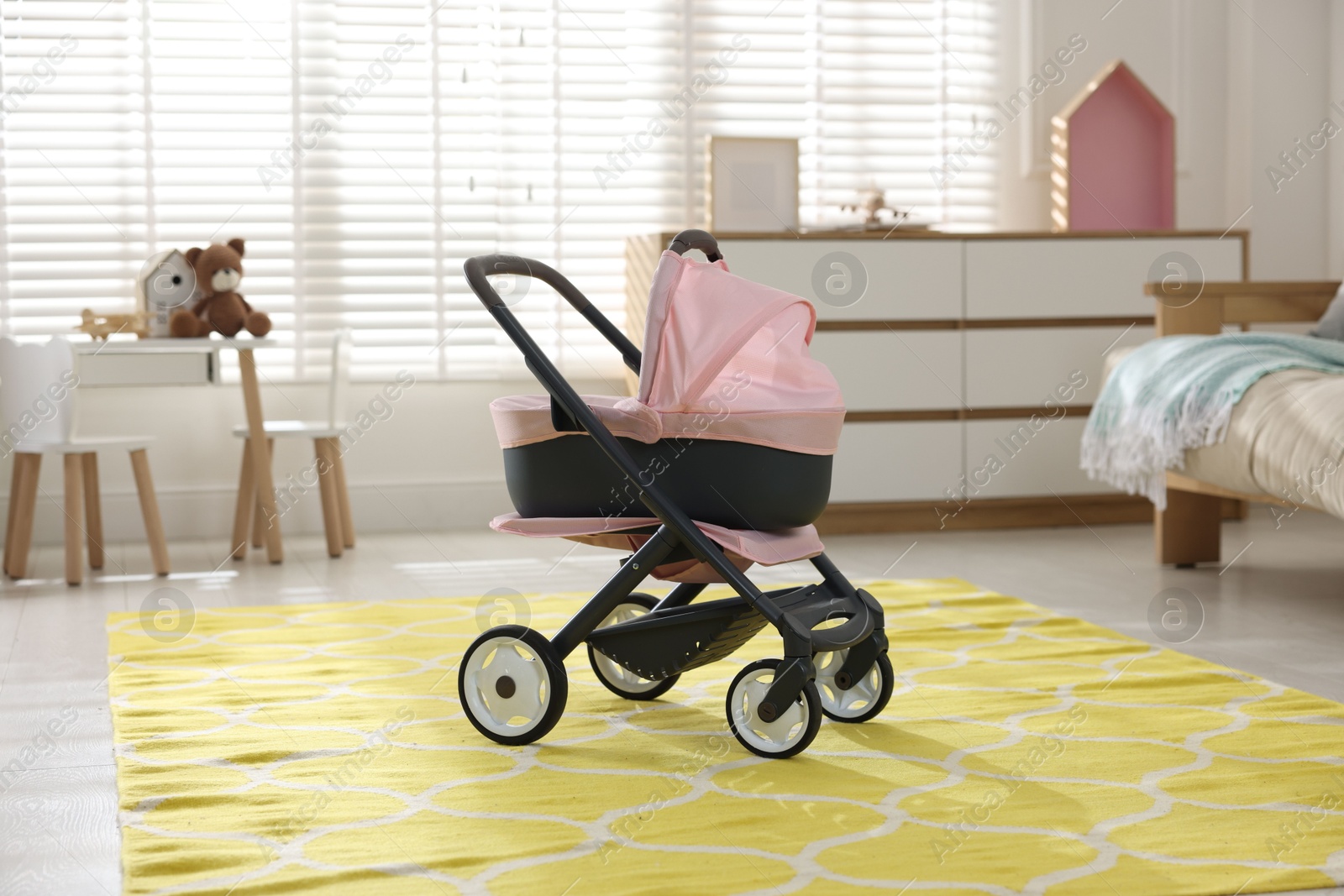 Photo of Doll stroller in children's room. Kid's toy