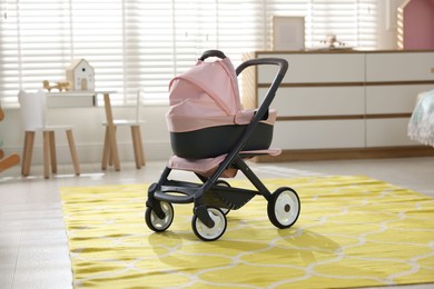 Photo of Doll stroller in children's room. Kid's toy