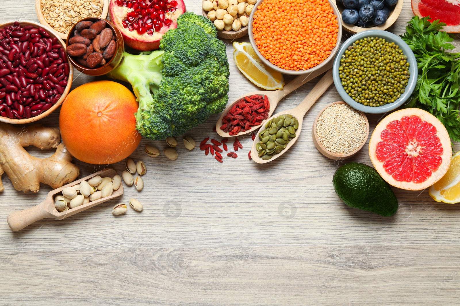 Photo of Different superfood products on wooden table, flat lay. Space for text