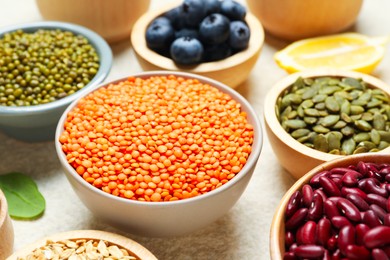 Photo of Different superfood products on light table, closeup