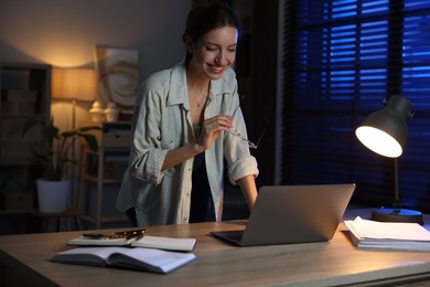 Photo of Woman working on laptop at desk in home office