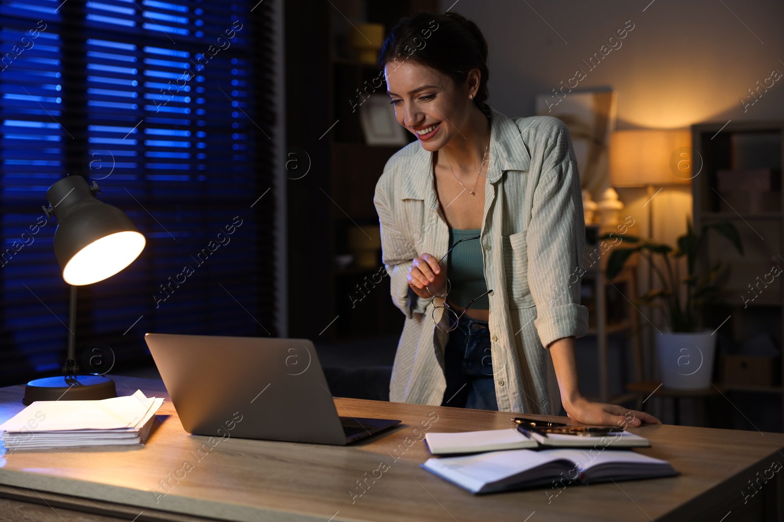 Photo of Woman working on laptop at desk in home office