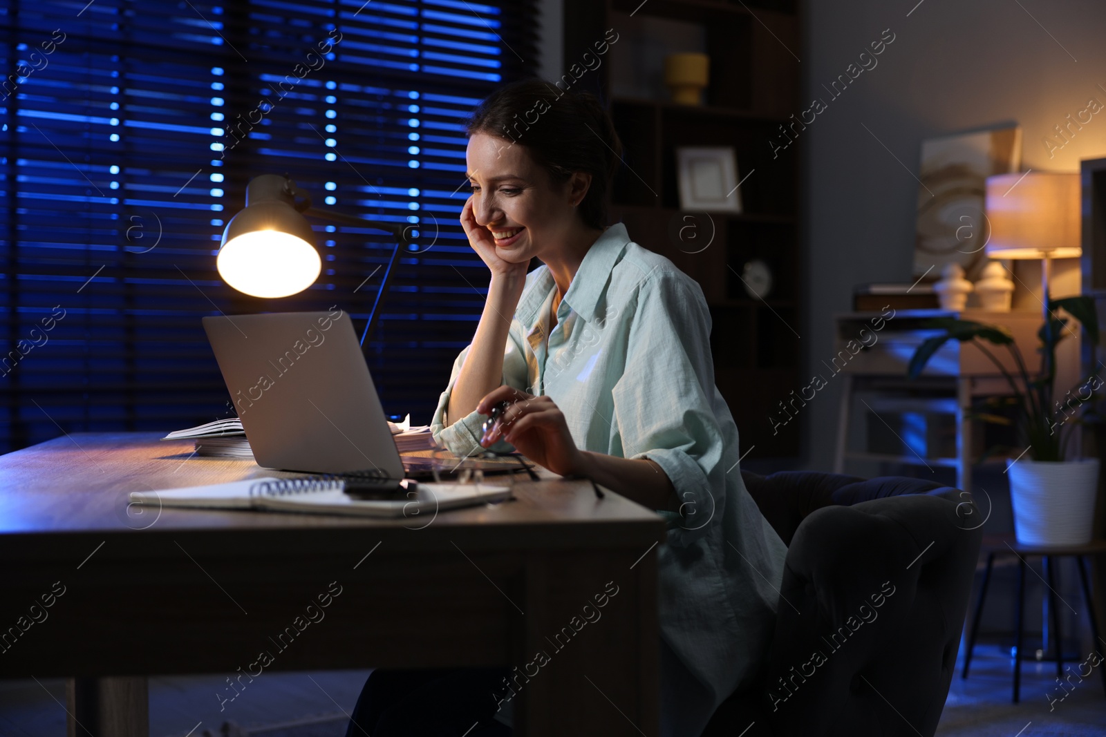 Photo of Woman working on laptop at desk in home office