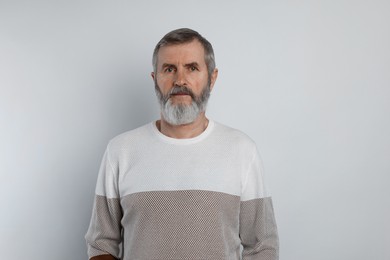 Photo of Portrait of mature man on white background