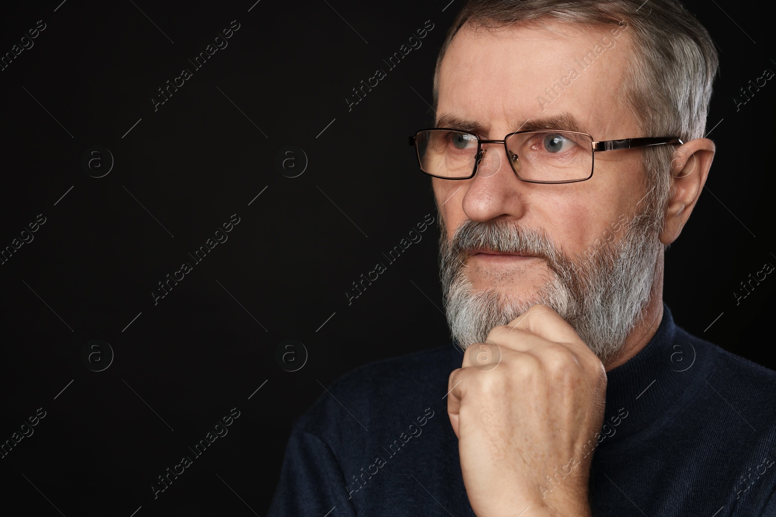 Photo of Portrait of mature man in glasses on black background, space for text