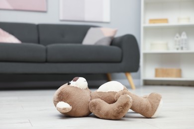 Photo of Lost brown bear on floor in room, closeup