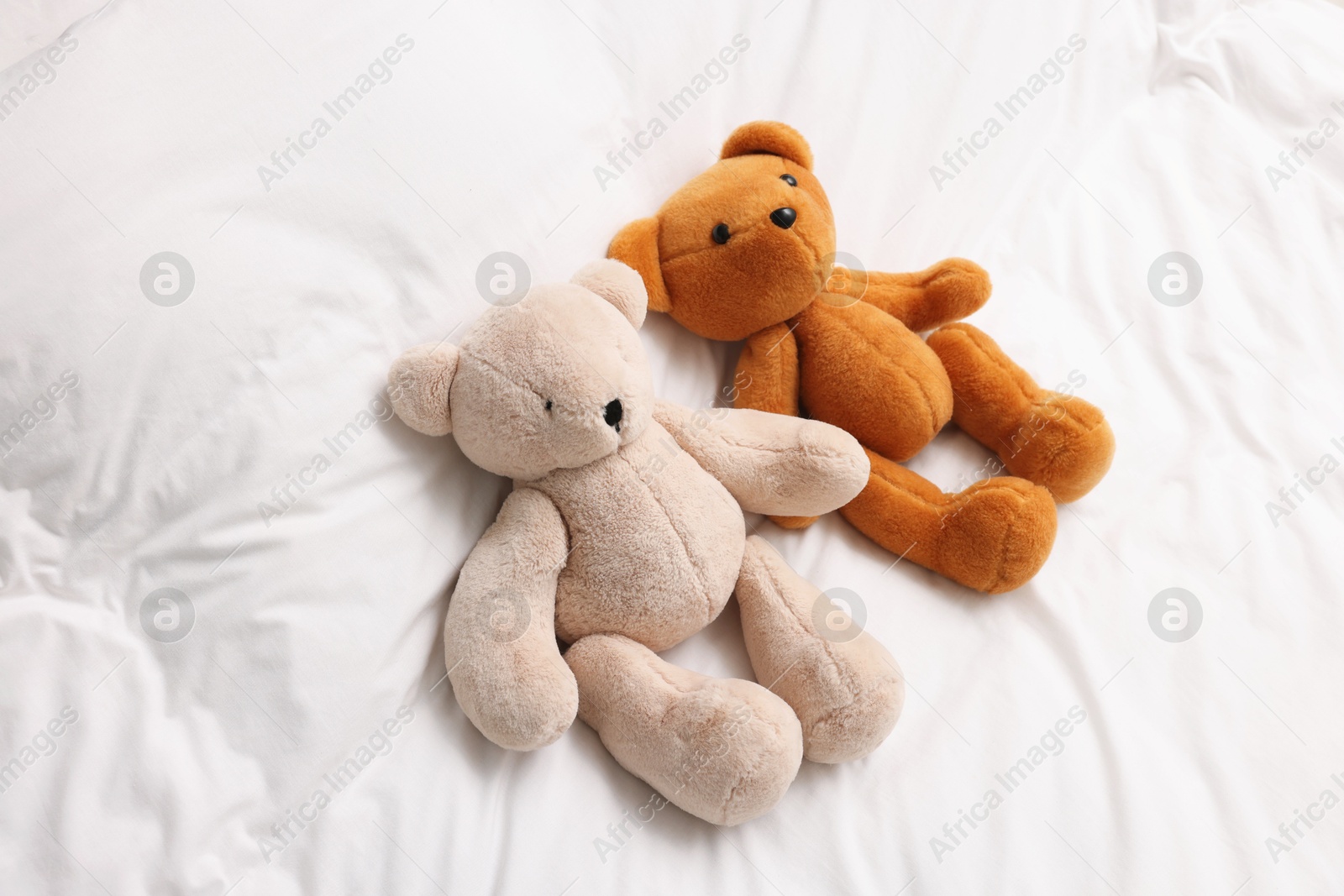 Photo of Two cute plush teddy bears on bed