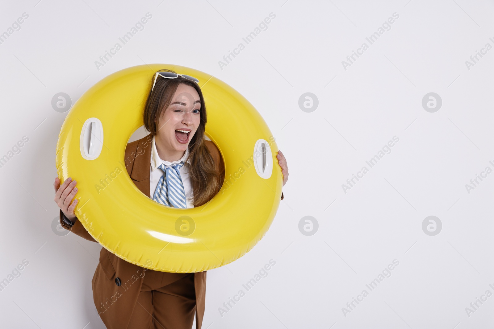 Photo of Businesswoman with inflatable ring and sunglasses on white background, space for text