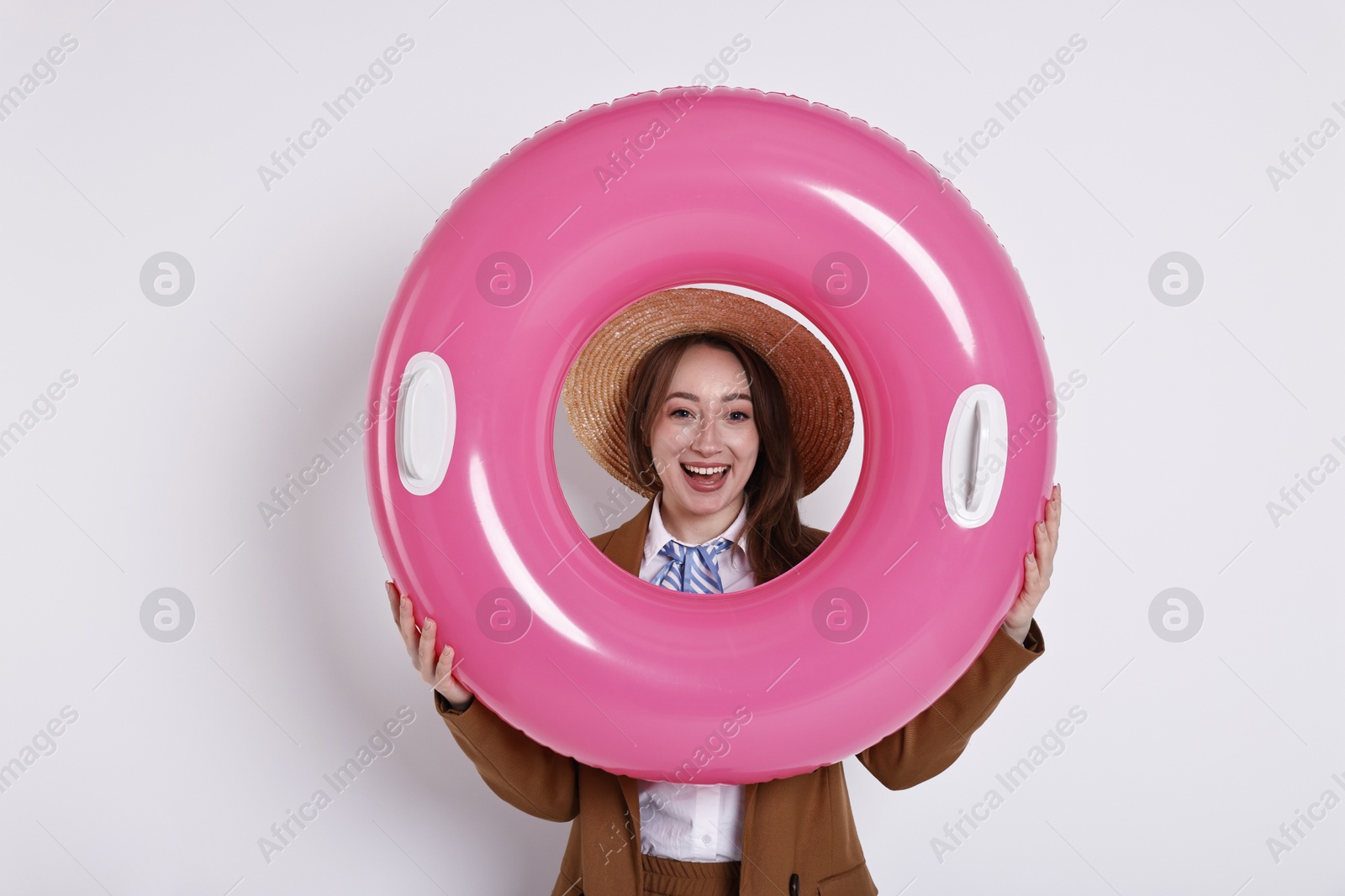 Photo of Businesswoman with inflatable ring and straw hat on white background