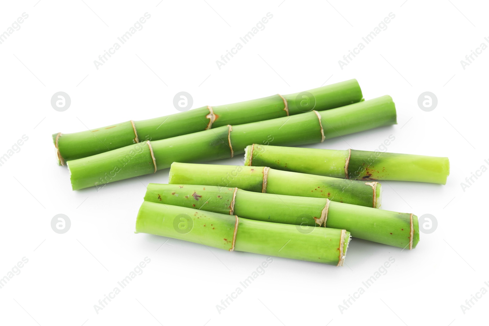 Photo of Cut green bamboo stems isolated on white