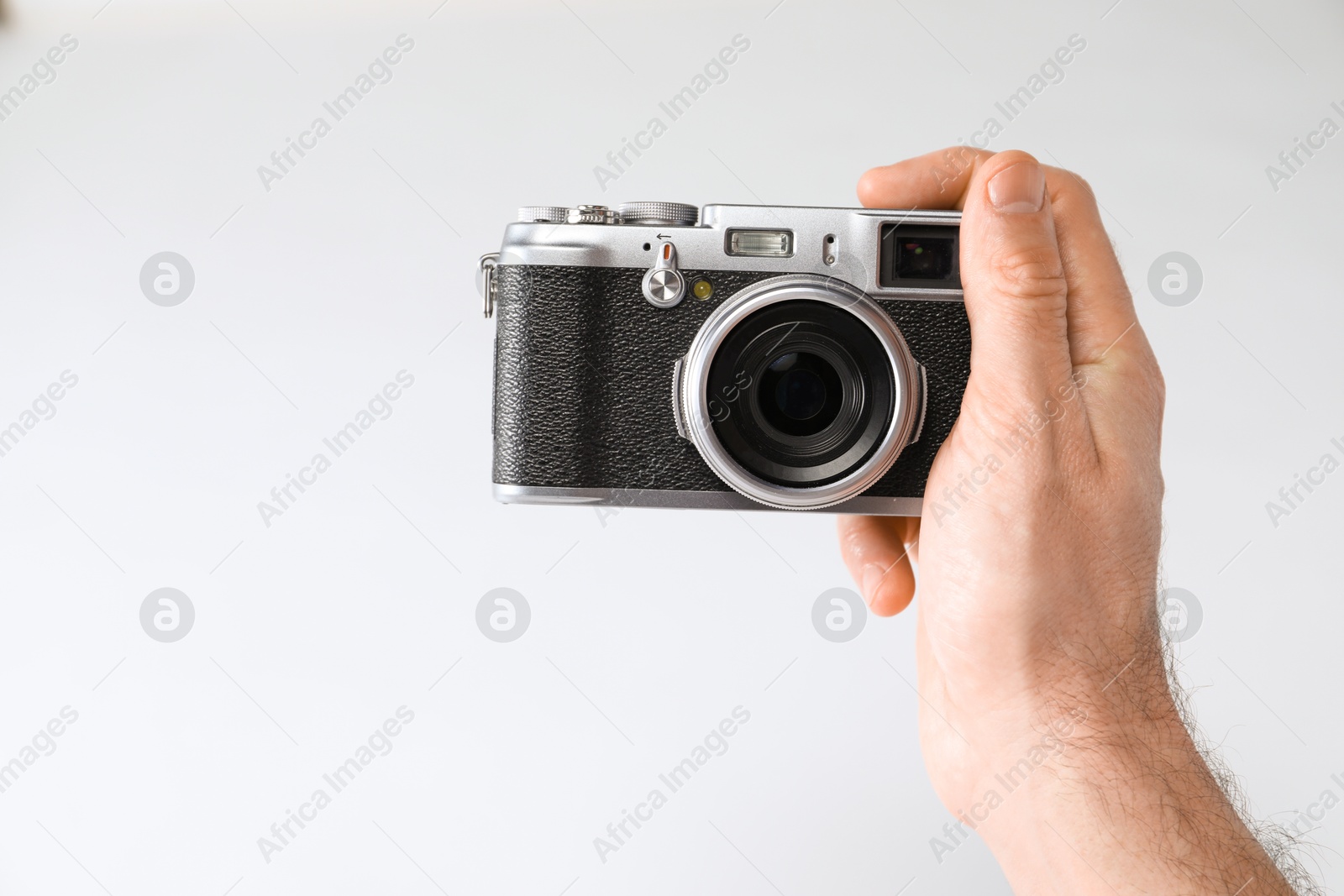 Photo of Photographer with vintage camera on white background, closeup. Space for text