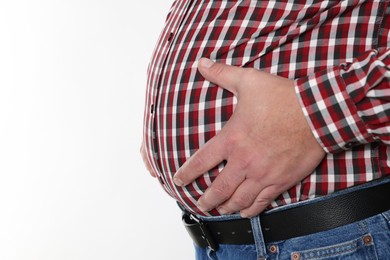 Photo of Overweight man in tight shirt on white background, closeup. Space for text