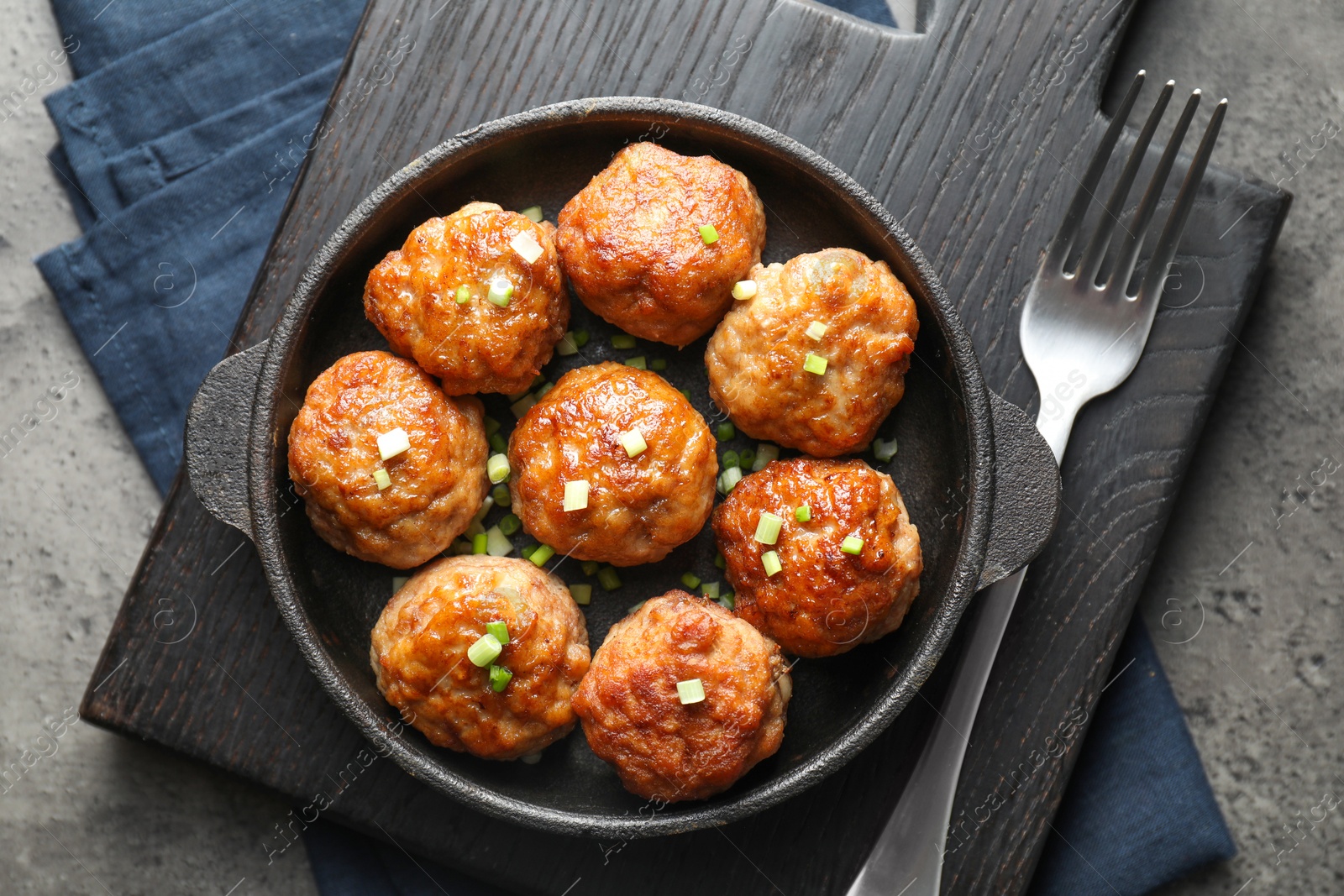 Photo of Tasty meatballs served on grey table, flat lay