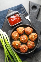 Photo of Tasty meatballs served on grey table, flat lay