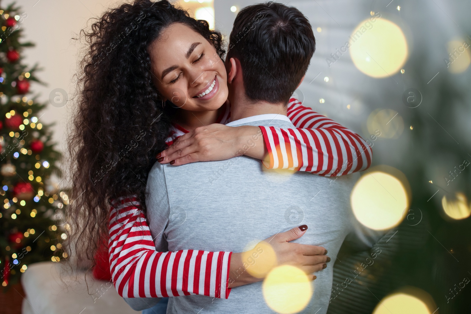 Photo of Happy couple hugging at home. Christmas celebration