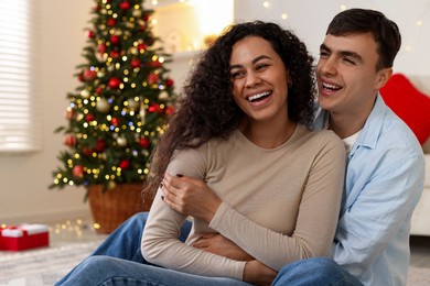 Photo of Happy couple spending time together at home. Christmas celebration