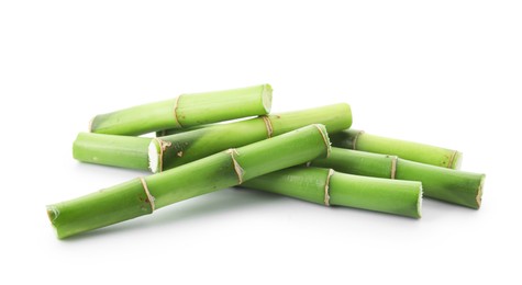 Photo of Cut green bamboo stems isolated on white