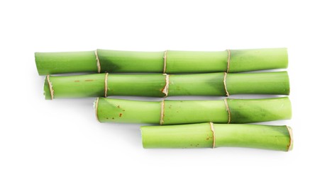 Photo of Cut green bamboo stems isolated on white, top view