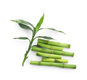 Photo of Cut green bamboo stems and leaves isolated on white, top view