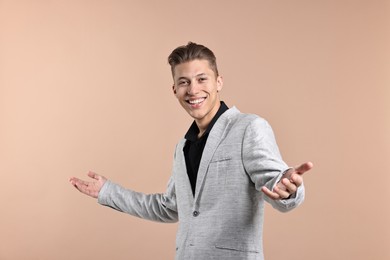 Photo of Happy businessman welcoming clients or partners on beige background