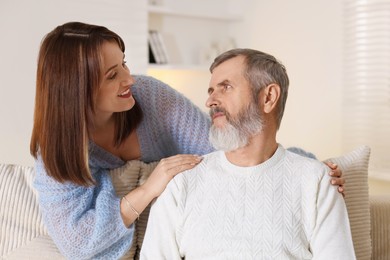 Photo of Happy adult daughter and her father spending time together at home