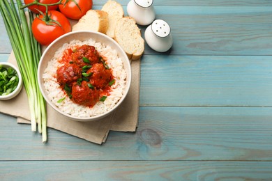 Photo of Tasty meatballs with sauce, rice and products on light blue wooden table, flat lay. Space for text