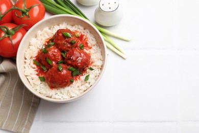 Photo of Tasty meatballs with sauce, rice and products on white tiled table, flat lay. Space for text