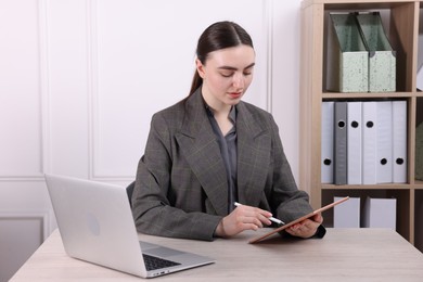 Photo of Electronic signature. Woman using stylus and tablet at wooden table indoors