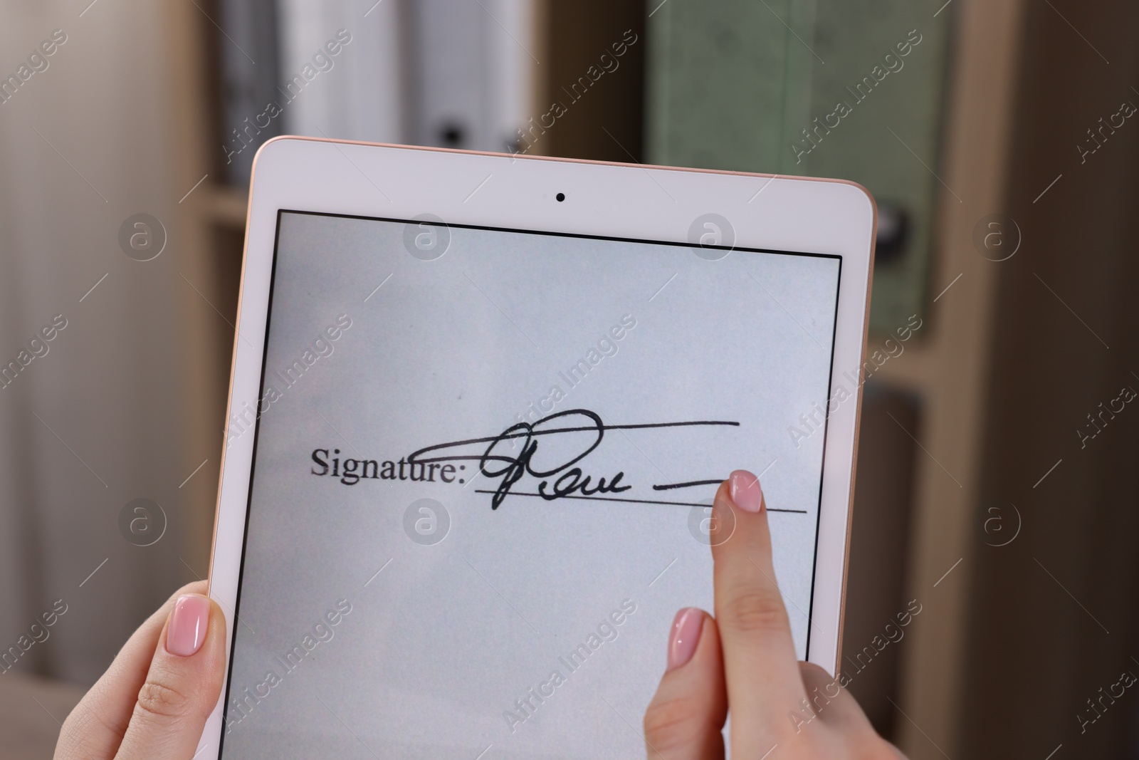 Photo of Electronic signature. Woman using tablet indoors, closeup