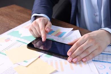 Photo of Electronic signature. Woman using smartphone at table, closeup