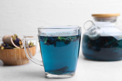 Photo of Delicious butterfly pea flower tea on white table