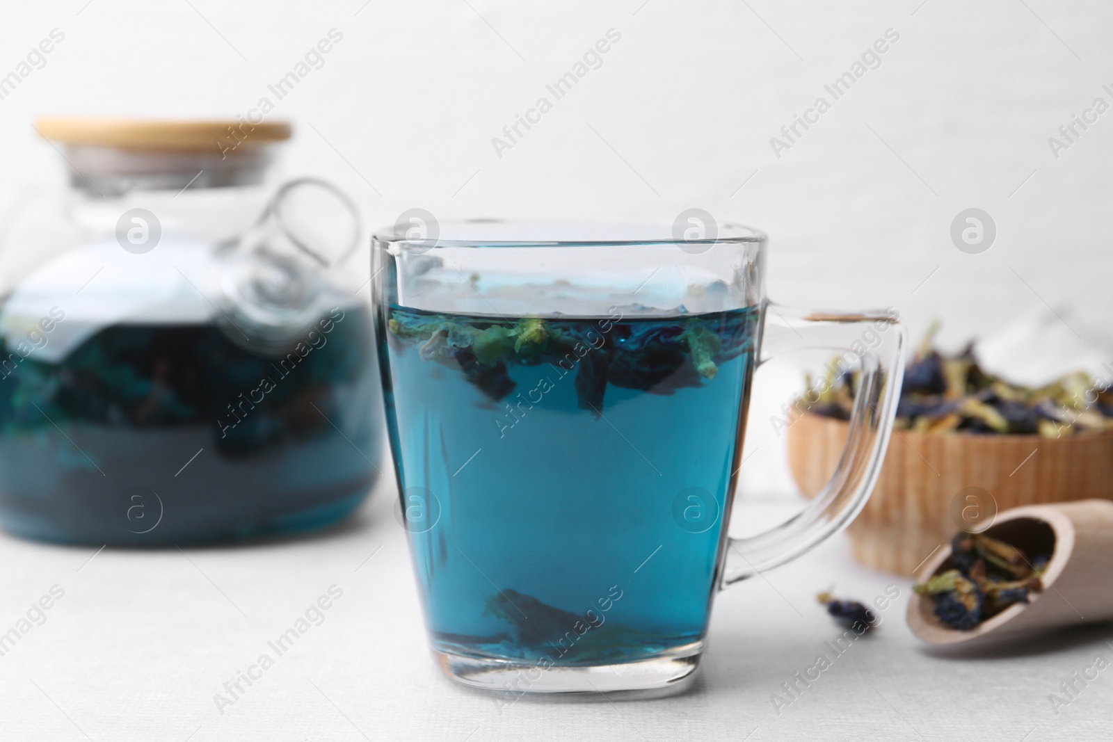 Delicious butterfly pea flower tea on white table Photo of Delicious butterfly pea flower tea on white table