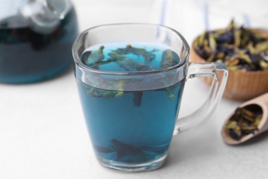 Delicious butterfly pea flower tea on white table, closeup