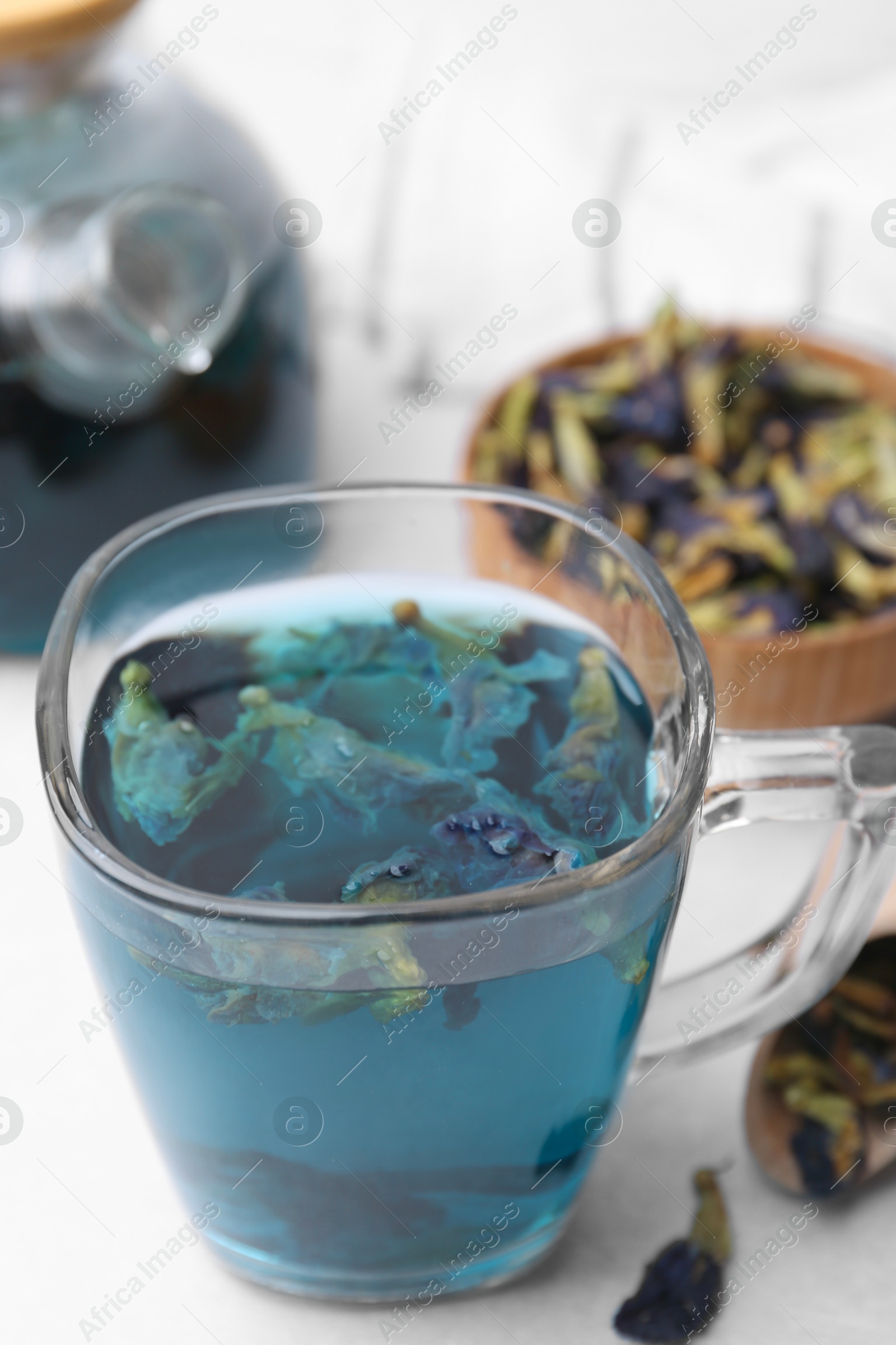 Delicious butterfly pea flower tea on white table, closeup Photo of Delicious butterfly pea flower tea on white table, closeup