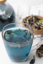 Photo of Delicious butterfly pea flower tea on white table, closeup