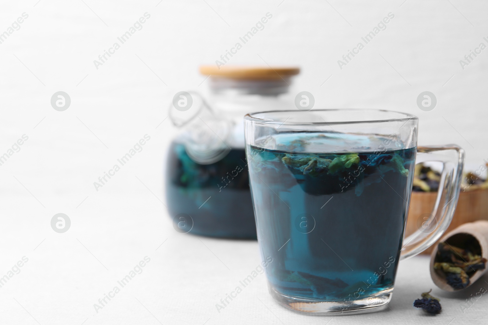 Delicious butterfly pea flower tea on white table Photo of Delicious butterfly pea flower tea on white table