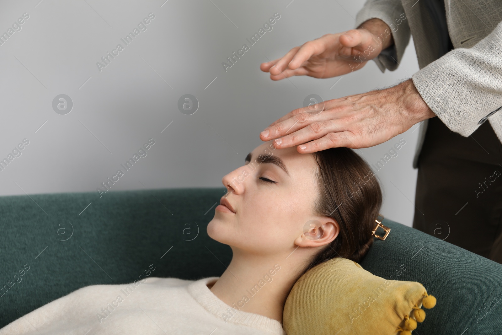 Photo of Psychologist working with patient during hypnosis session indoors, closeup