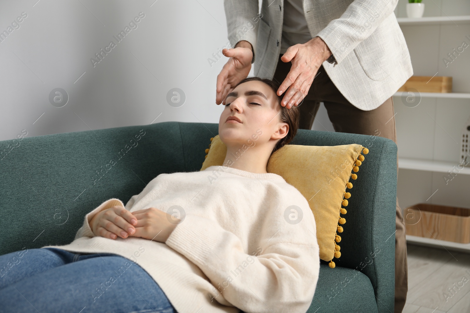 Photo of Psychologist working with patient during hypnosis session indoors, closeup