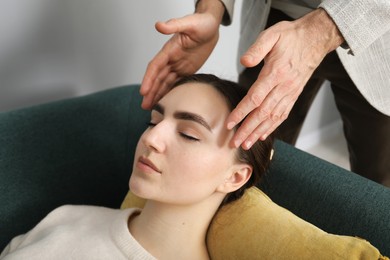 Photo of Psychologist working with patient during hypnosis session indoors, closeup