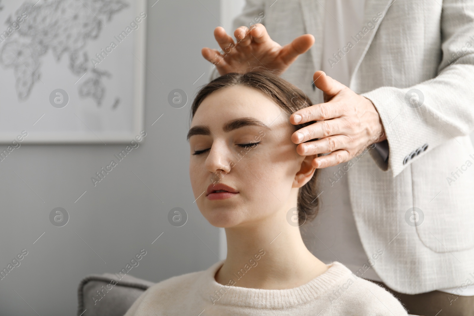 Photo of Psychologist working with patient during hypnosis session indoors, closeup. Space for text