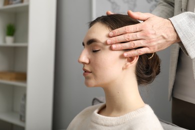 Photo of Psychologist working with patient during hypnosis session indoors, closeup. Space for text